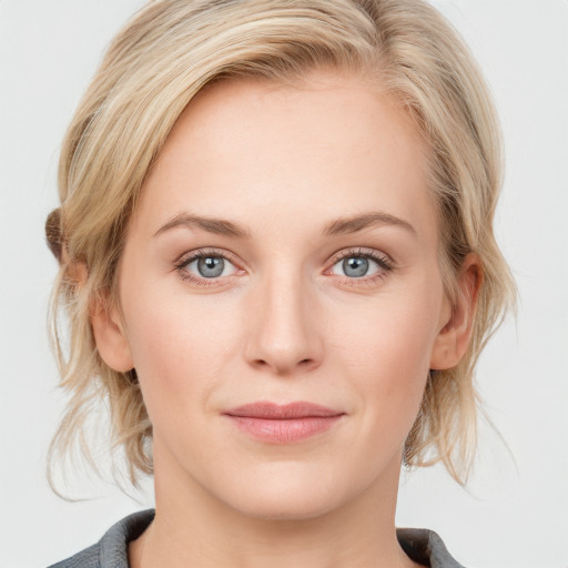 Joyful white young-adult female with medium  brown hair and blue eyes