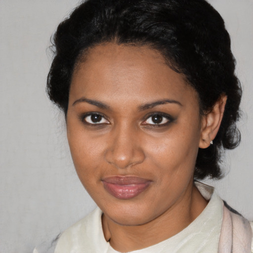 Joyful black young-adult female with short  brown hair and brown eyes