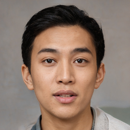 Joyful white young-adult male with short  black hair and brown eyes
