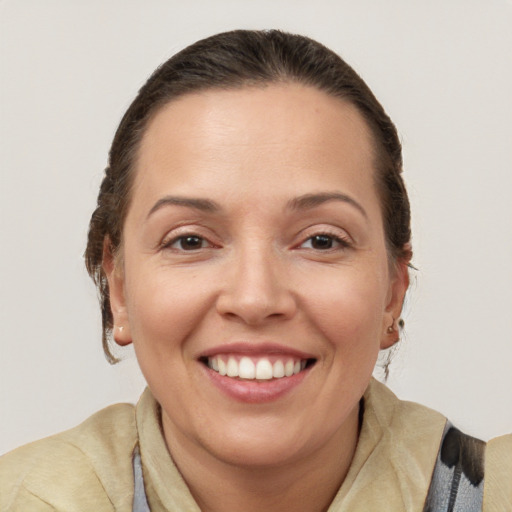 Joyful white adult female with medium  brown hair and brown eyes