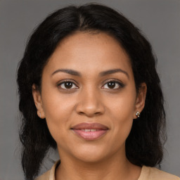 Joyful latino young-adult female with medium  brown hair and brown eyes