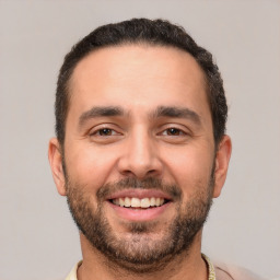 Joyful white young-adult male with short  black hair and brown eyes