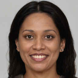 Joyful white adult female with long  brown hair and brown eyes