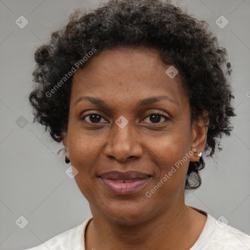 Joyful black adult female with short  brown hair and brown eyes