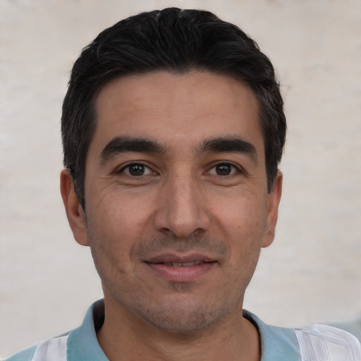 Joyful white young-adult male with short  black hair and brown eyes
