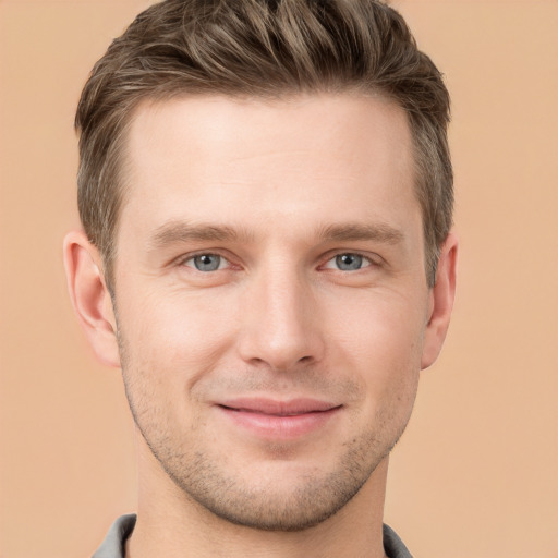 Joyful white young-adult male with short  brown hair and grey eyes