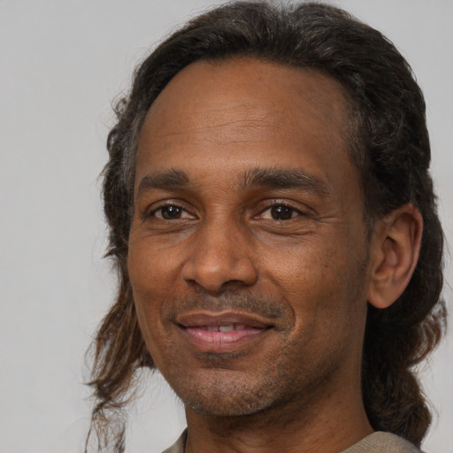 Joyful black adult male with short  brown hair and brown eyes