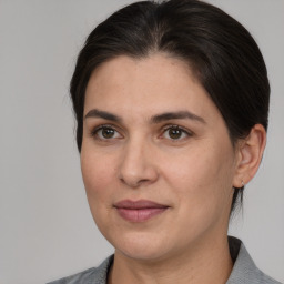 Joyful white adult female with medium  brown hair and brown eyes