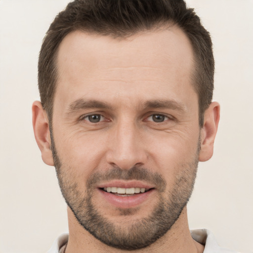 Joyful white young-adult male with short  brown hair and brown eyes