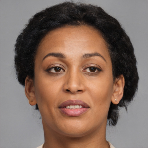 Joyful latino adult female with short  brown hair and brown eyes