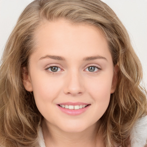 Joyful white young-adult female with long  brown hair and blue eyes