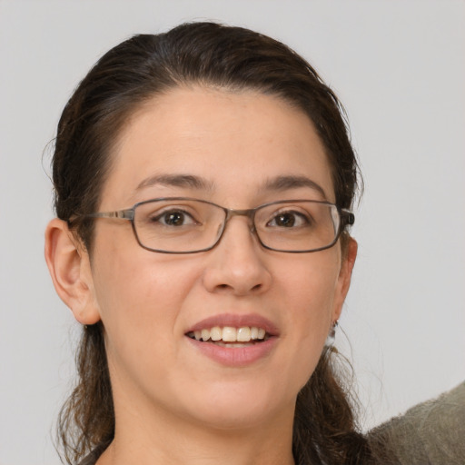 Joyful white young-adult female with medium  brown hair and grey eyes