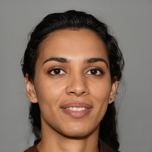 Joyful latino young-adult female with medium  black hair and brown eyes