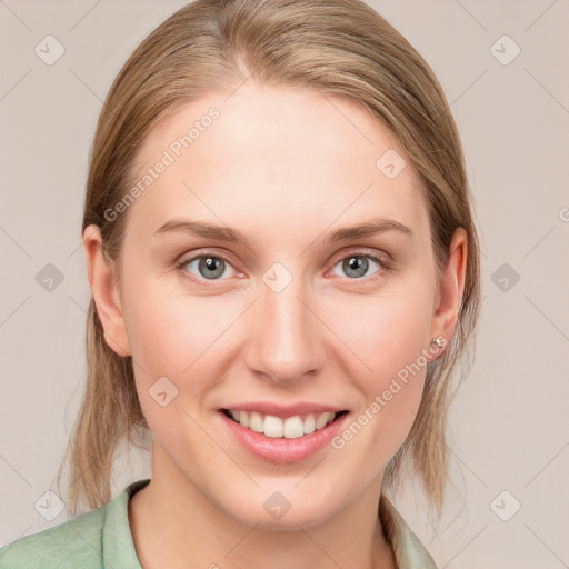 Joyful white young-adult female with medium  brown hair and blue eyes