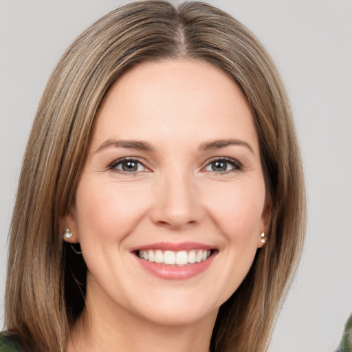 Joyful white young-adult female with medium  brown hair and green eyes