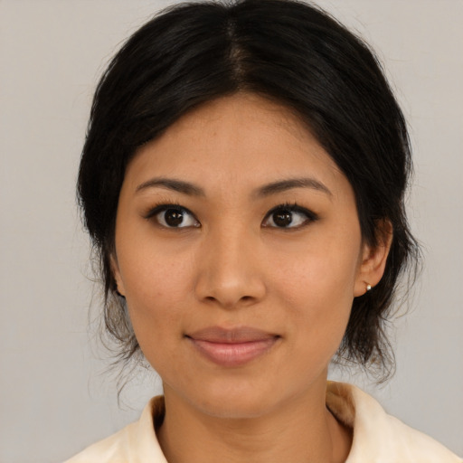 Joyful asian young-adult female with medium  black hair and brown eyes