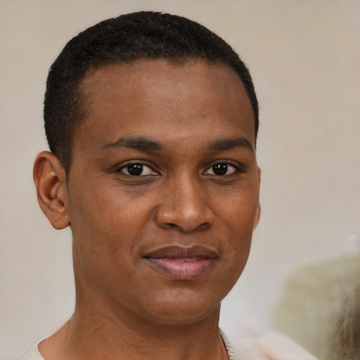 Joyful black young-adult male with short  brown hair and brown eyes