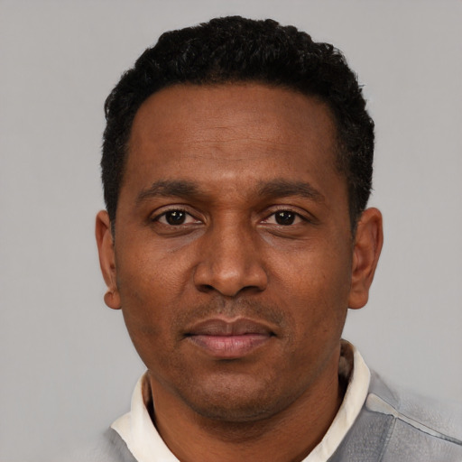 Neutral latino adult male with short  black hair and brown eyes