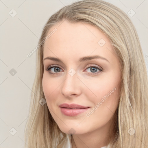 Joyful white young-adult female with long  brown hair and blue eyes