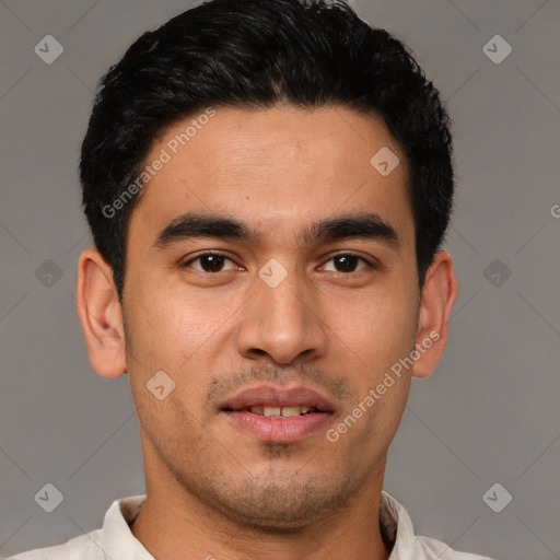 Joyful white young-adult male with short  black hair and brown eyes