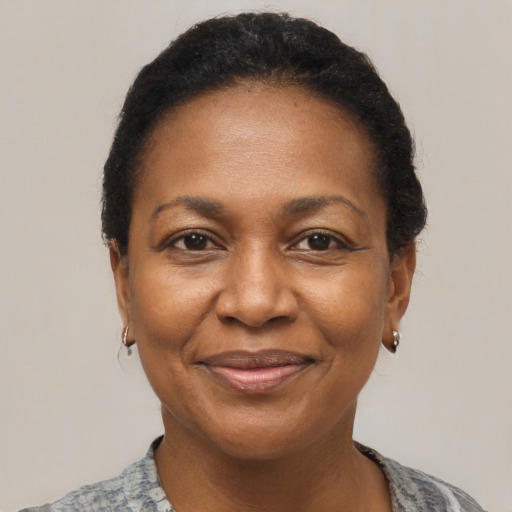 Joyful black adult female with short  black hair and brown eyes