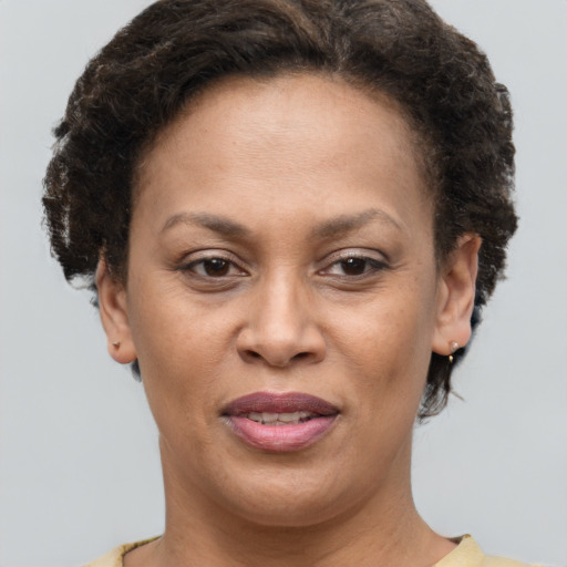 Joyful black adult female with short  brown hair and brown eyes