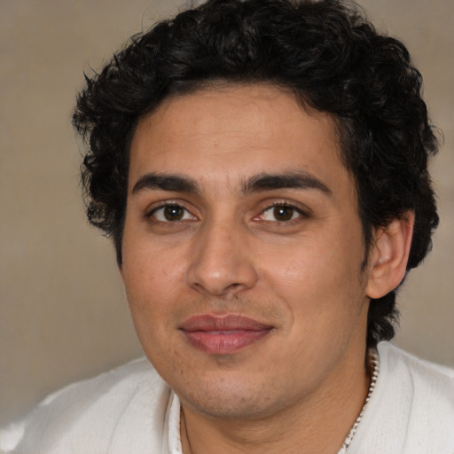 Joyful latino young-adult male with short  brown hair and brown eyes