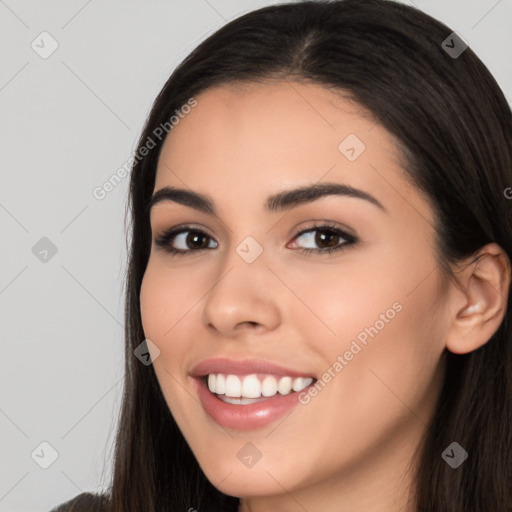 Joyful white young-adult female with long  black hair and brown eyes