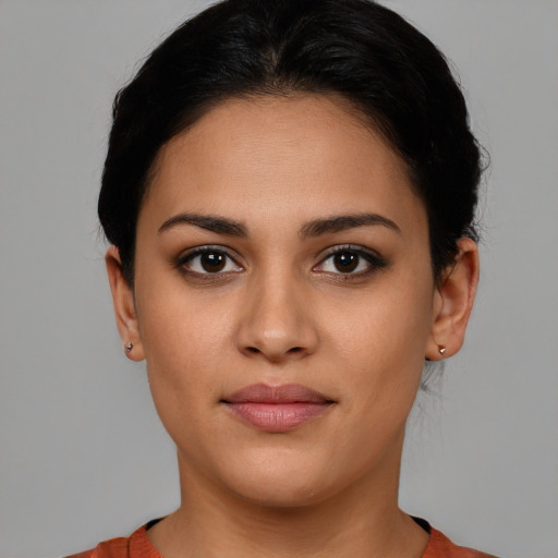 Joyful latino young-adult female with short  brown hair and brown eyes