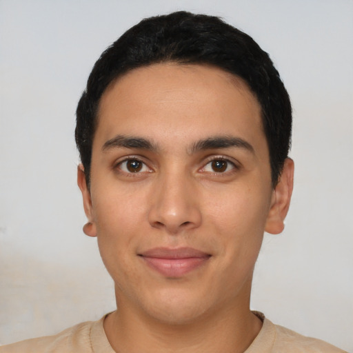 Joyful latino young-adult male with short  black hair and brown eyes