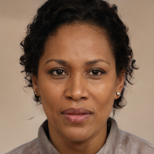 Joyful black adult female with short  brown hair and brown eyes