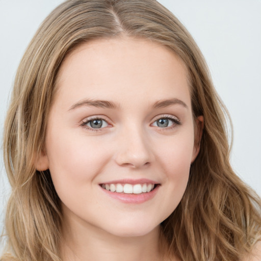 Joyful white young-adult female with long  brown hair and blue eyes