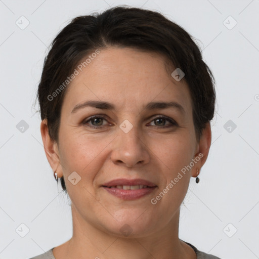 Joyful white adult female with short  brown hair and grey eyes