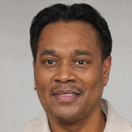 Joyful latino adult male with short  black hair and brown eyes