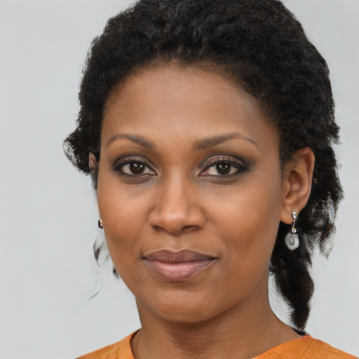 Joyful black young-adult female with medium  brown hair and brown eyes