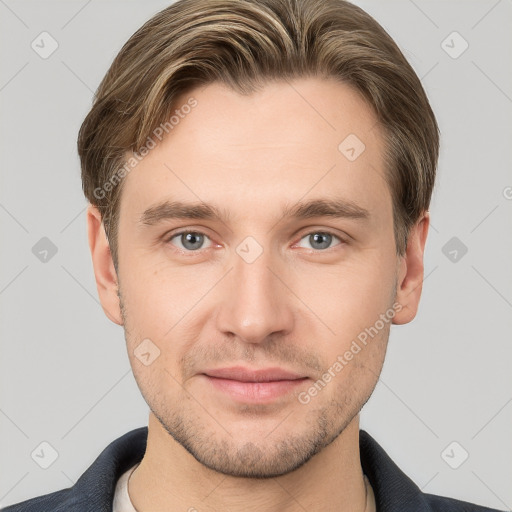 Joyful white young-adult male with short  brown hair and grey eyes