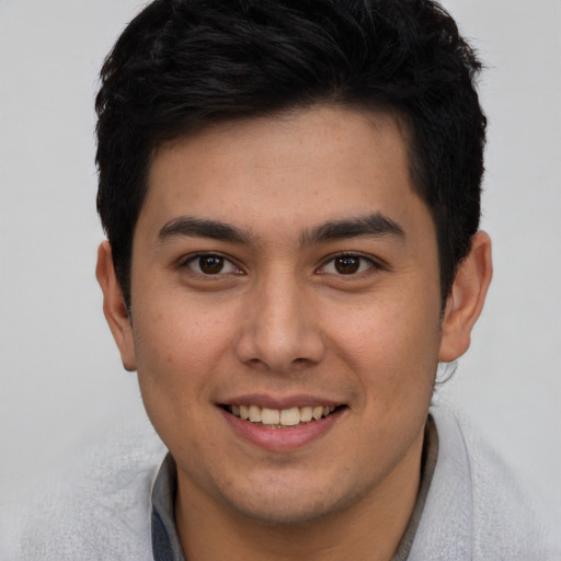 Joyful latino young-adult male with short  brown hair and brown eyes