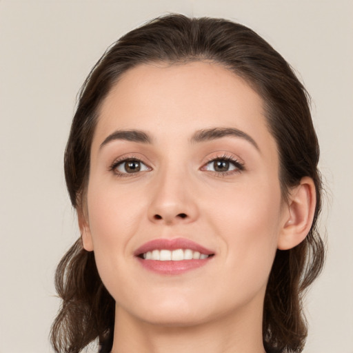 Joyful white young-adult female with medium  brown hair and brown eyes