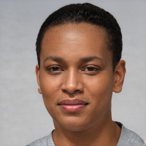 Joyful black young-adult female with short  black hair and brown eyes