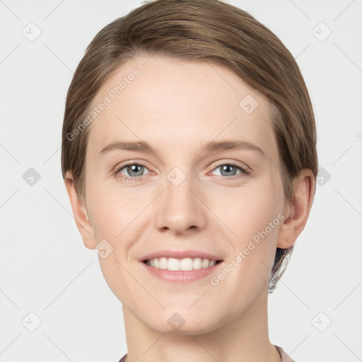 Joyful white young-adult female with short  brown hair and grey eyes