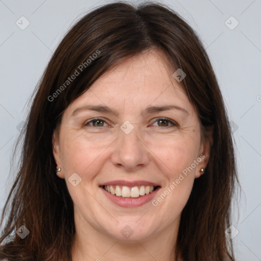 Joyful white adult female with long  brown hair and brown eyes