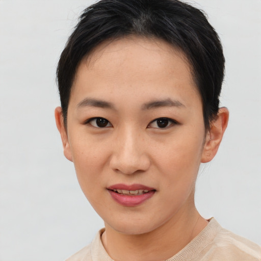 Joyful asian young-adult female with short  brown hair and brown eyes