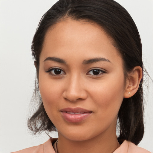 Joyful latino young-adult female with medium  brown hair and brown eyes