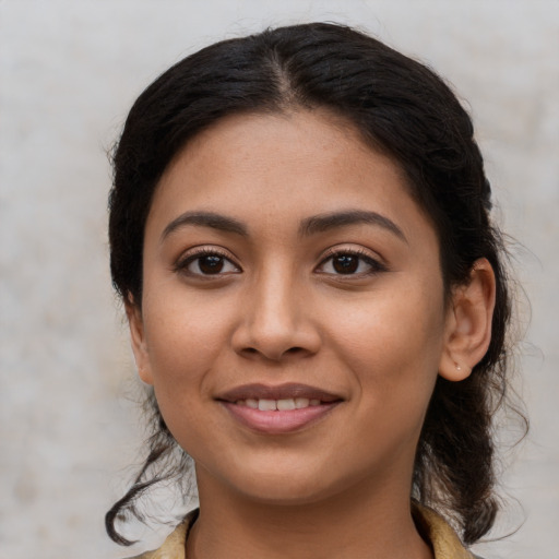 Joyful latino young-adult female with medium  black hair and brown eyes