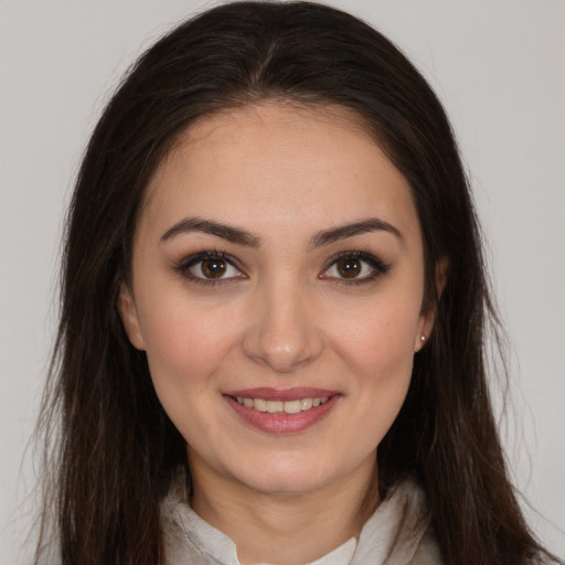 Joyful white young-adult female with long  brown hair and brown eyes