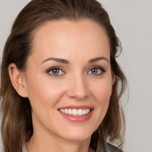 Joyful white young-adult female with long  brown hair and grey eyes