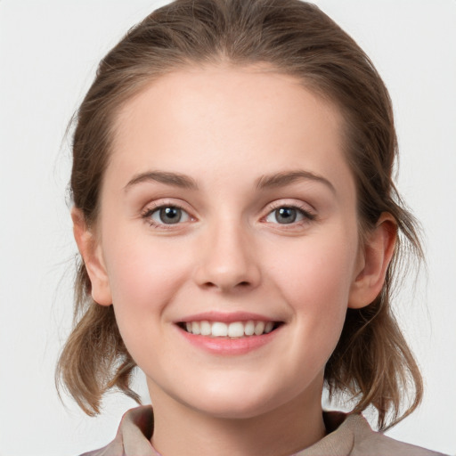 Joyful white child female with medium  brown hair and grey eyes