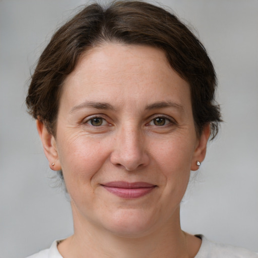 Joyful white adult female with short  brown hair and grey eyes