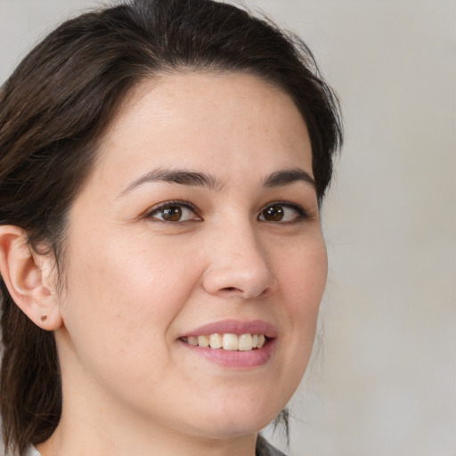 Joyful white young-adult female with medium  brown hair and brown eyes