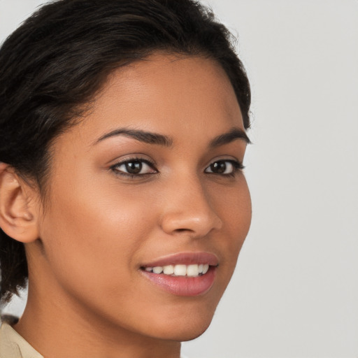 Joyful latino young-adult female with medium  brown hair and brown eyes